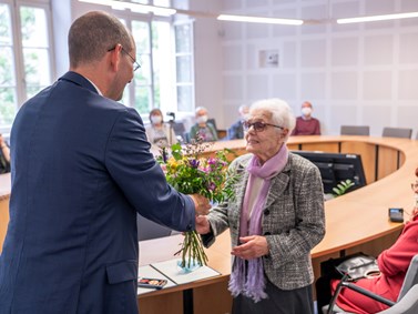 Německý velvyslanec Dr. Christoph Israng předává ocenění a květinu paní Kitty Galdové.