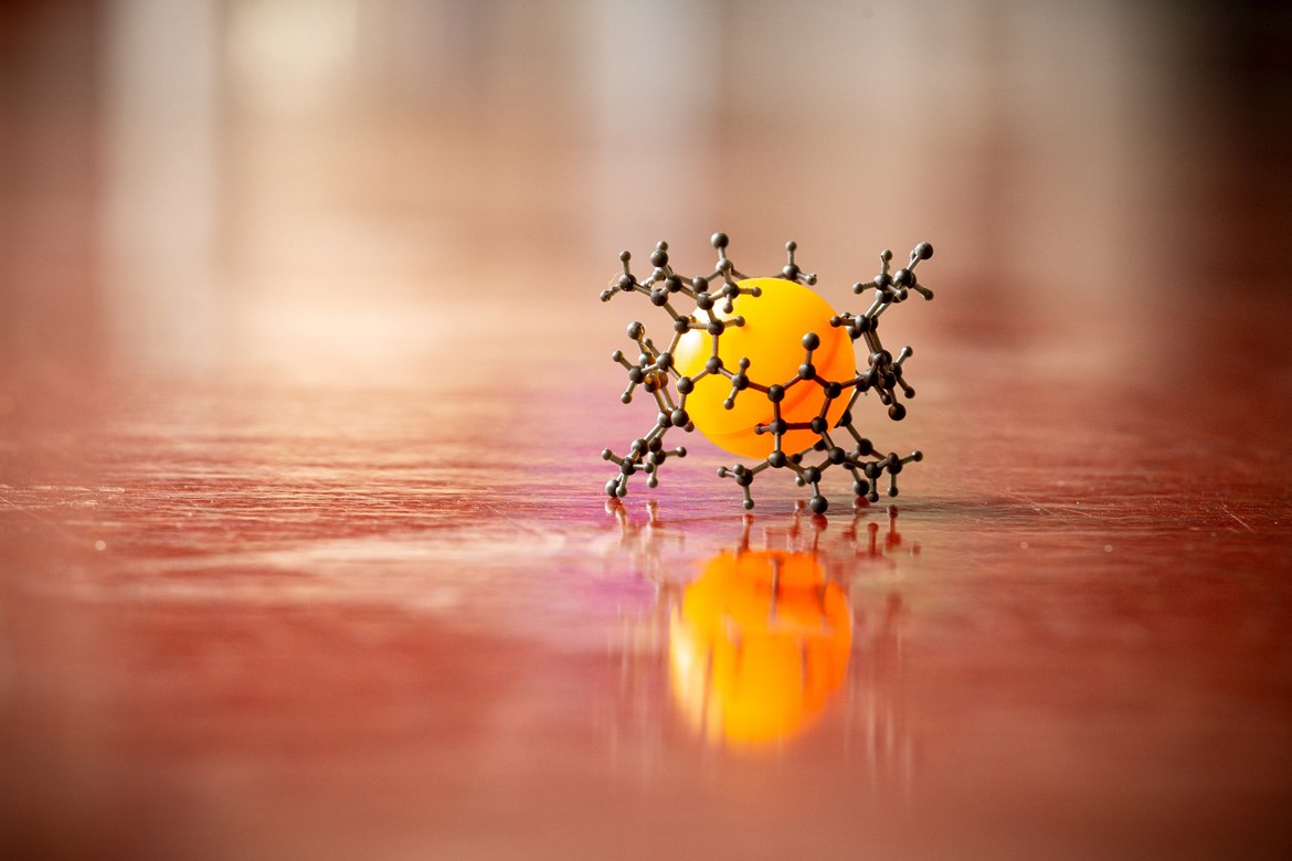 The outer, black structure represents bambusuril, while the orange ball indicates an anion bound inside. Photo: Helena Brunnerová 