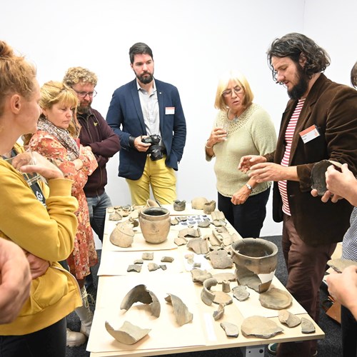  Conference participants in a discussion about medieval pottery from South Bohemia.