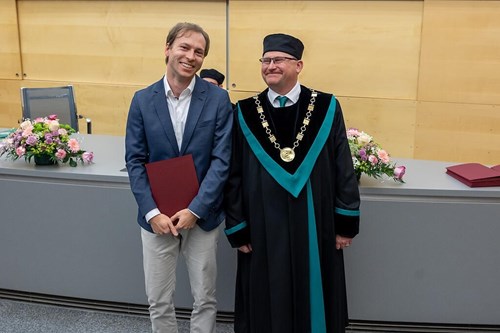 Dr. Michael Kroker receives the awards from the Dean Prof. Tomáš Kašparovský