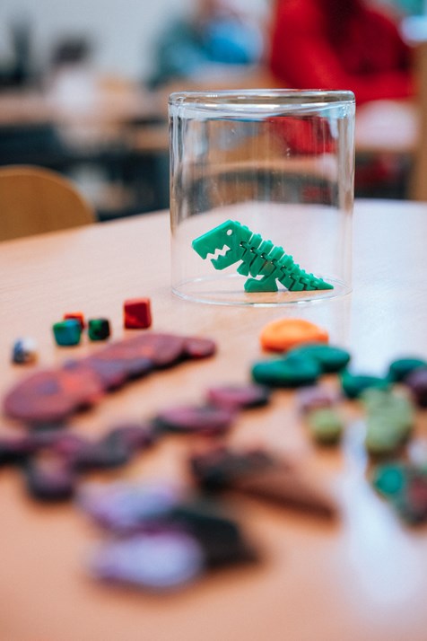 Lingebrosaur and tokens. Tools for motivating students to voluntarily solve challenging problems at the board. Lingebrosaur is the challenge mascot of the class. Tokens provide immunity against forced participation at the board. Photo: Irina Matusevič.
